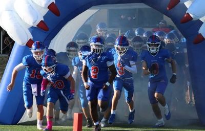 Conner players run through the smoke-filled Cougar tunnel