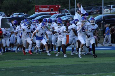 The Cougars run onto the field